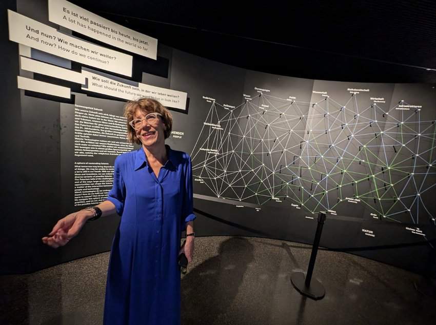 a woman standing in front of a large display Futurium Berlin sustainability Germany